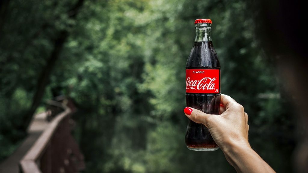 Coca Cola bottle in the woods