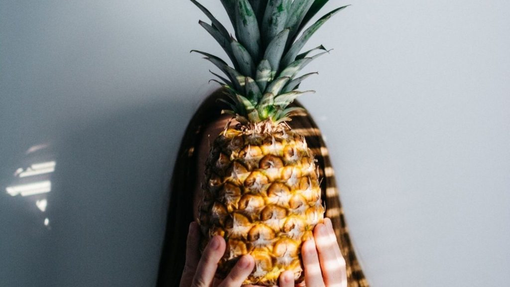Woman holding pineaple